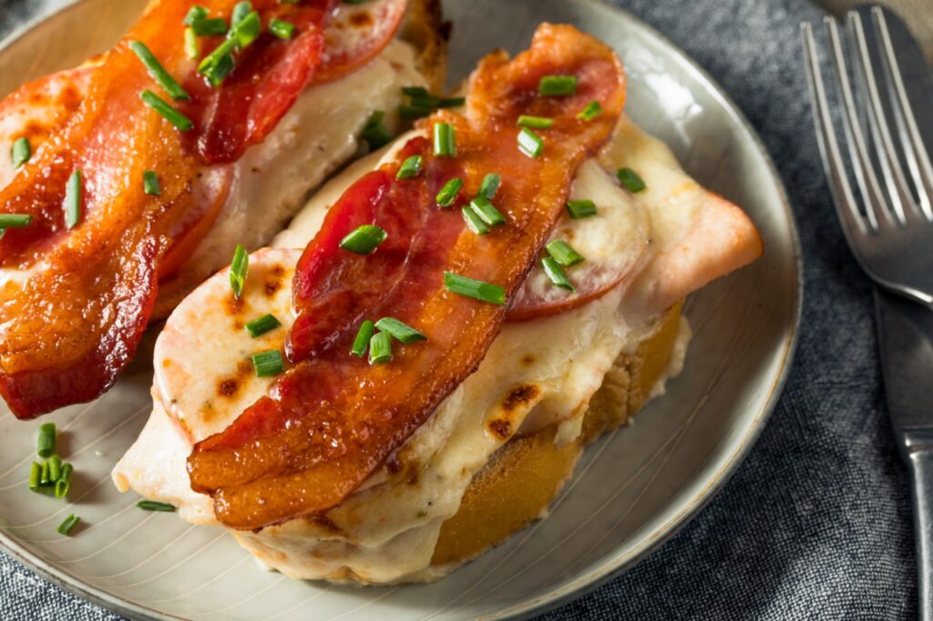 Homemade baked Kentucky hot brown with bacon chicken and cream sauce is a food idea for a day at the races fundraiser theme.