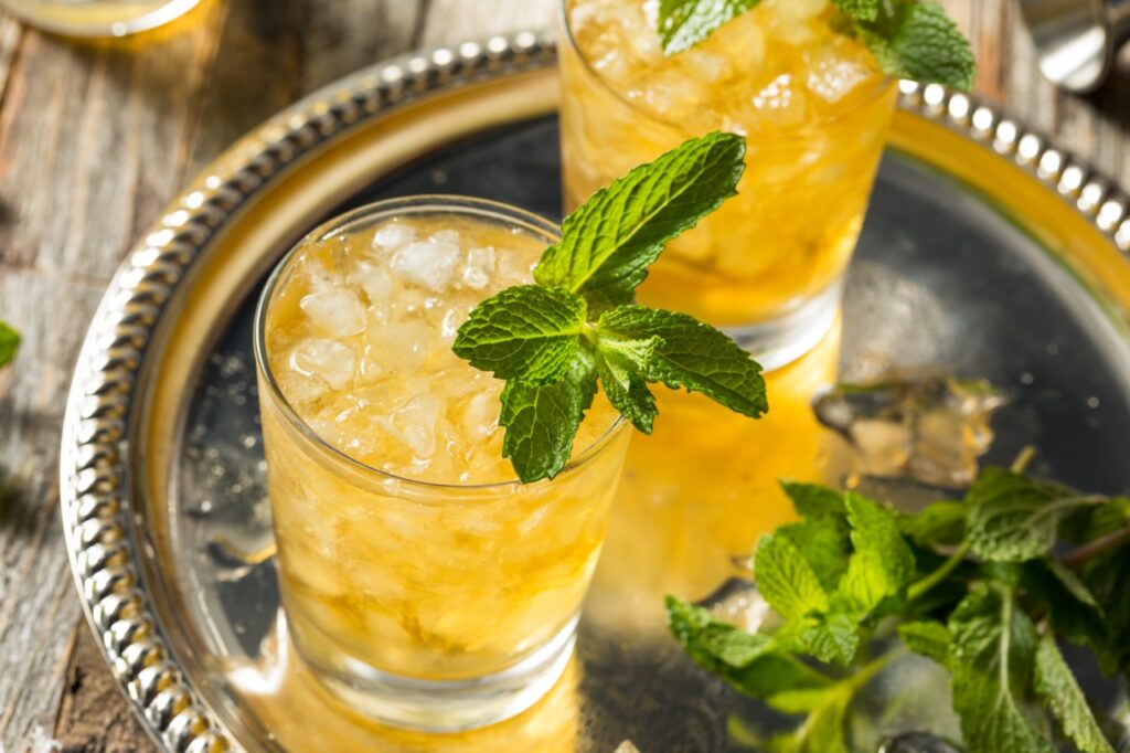 Homemade kentucky bourbon mint julep is a drink idea for a day at the races fundraiser theme.