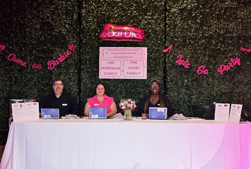 Barbie-Themed Fundraiser event registration desk. 