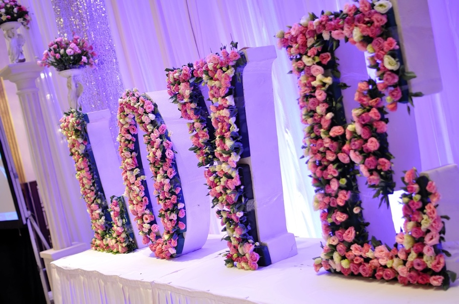 A close-up of flowers that spell love is a great wedding theme fundraiser venue decor idea