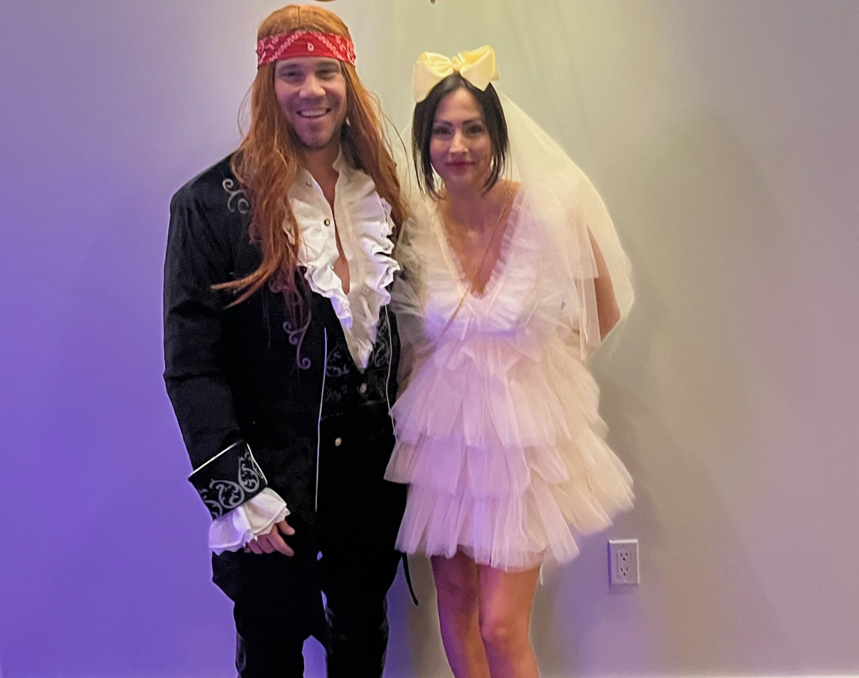 A couple dressed in a costume contest for a wedding theme fundraiser