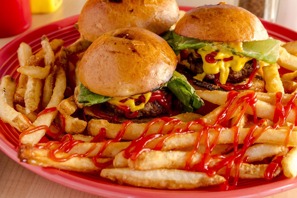 A plate of sliders and fries.