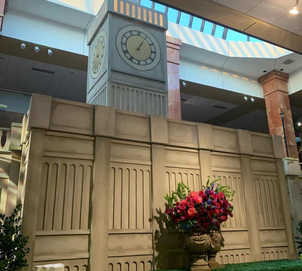 A clock tower in a building British inspired fundraiser theme entrance.