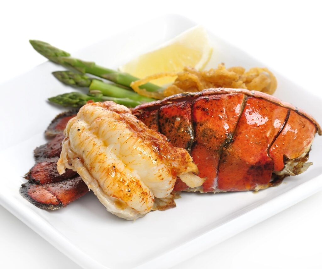 A plate of lobster and asparagus for a Sand and Sea or Yacht Theme Fundraiser.