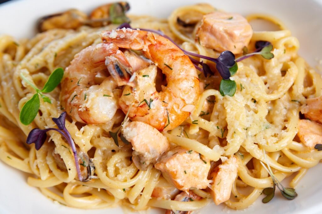 A plate of pasta with shrimp and seafood for a Sand and Sea or Yacht Theme Fundraiser.