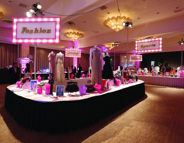 A display of clothing and accessories for a slient auction layout.