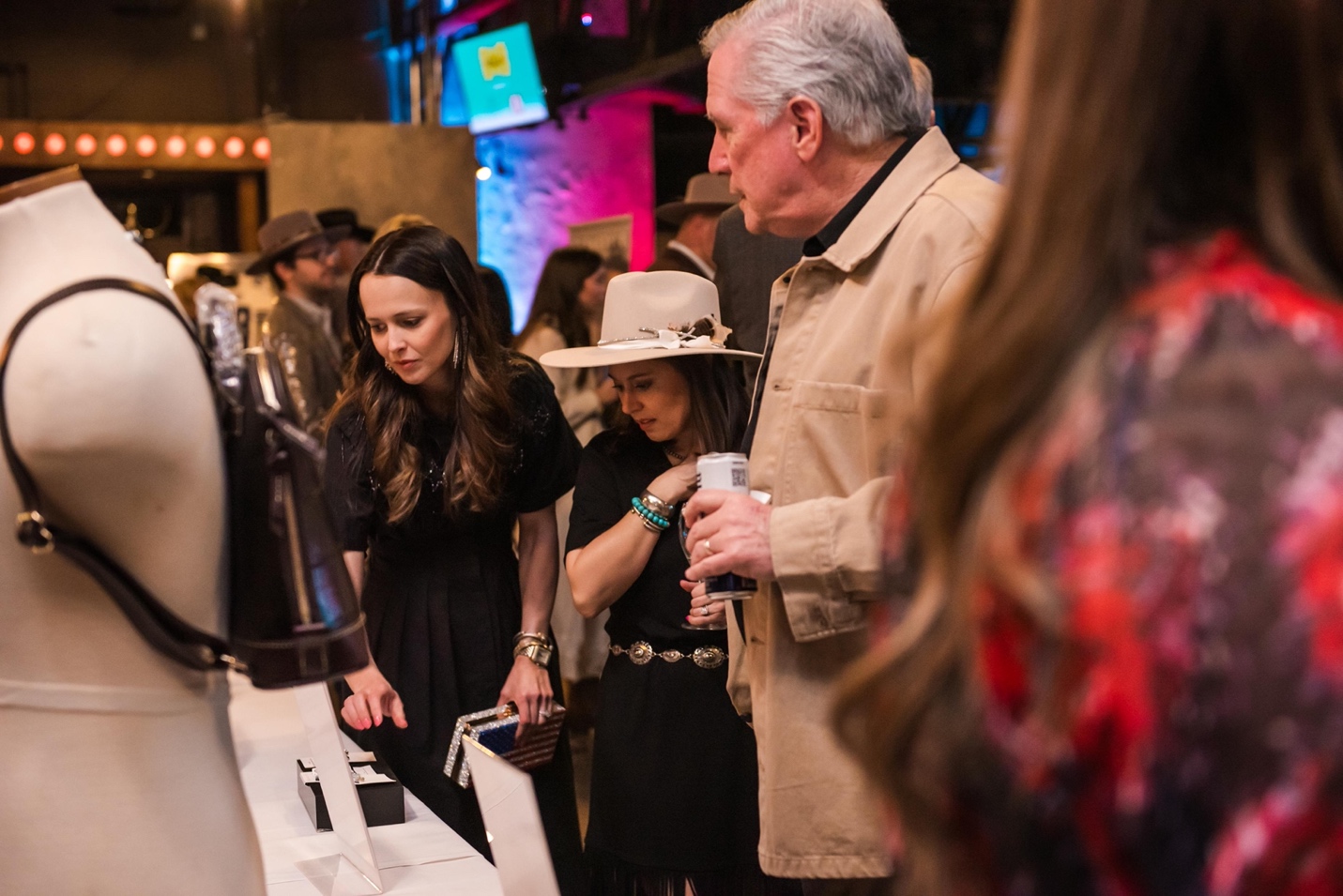 A group of people at a silent auction