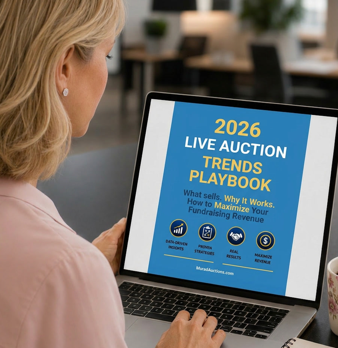 Nonprofit professional reviewing 2026 Live Auction Trends Playbook on laptop for fundraising strategy